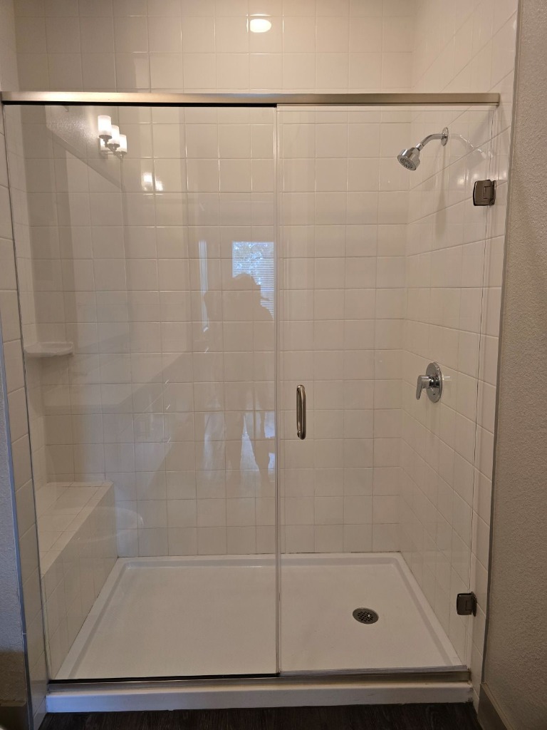 Clean shower glass and sparkling tile after restoration